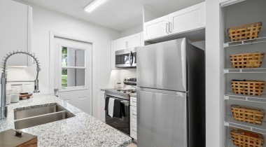Kitchen with Granite-Style Countertops and Stainless Steel Appliances at Our Pembroke Apartments