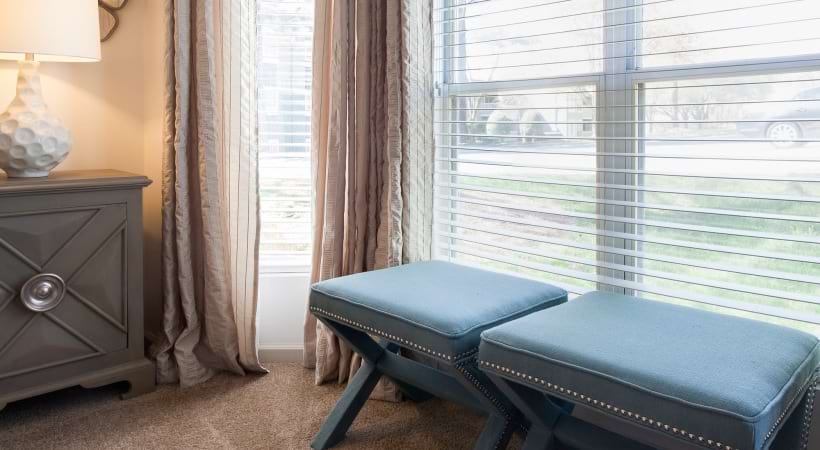 Well-Lit, Spacious Bedroom with Large Windows at Our Apartments in Cotswold