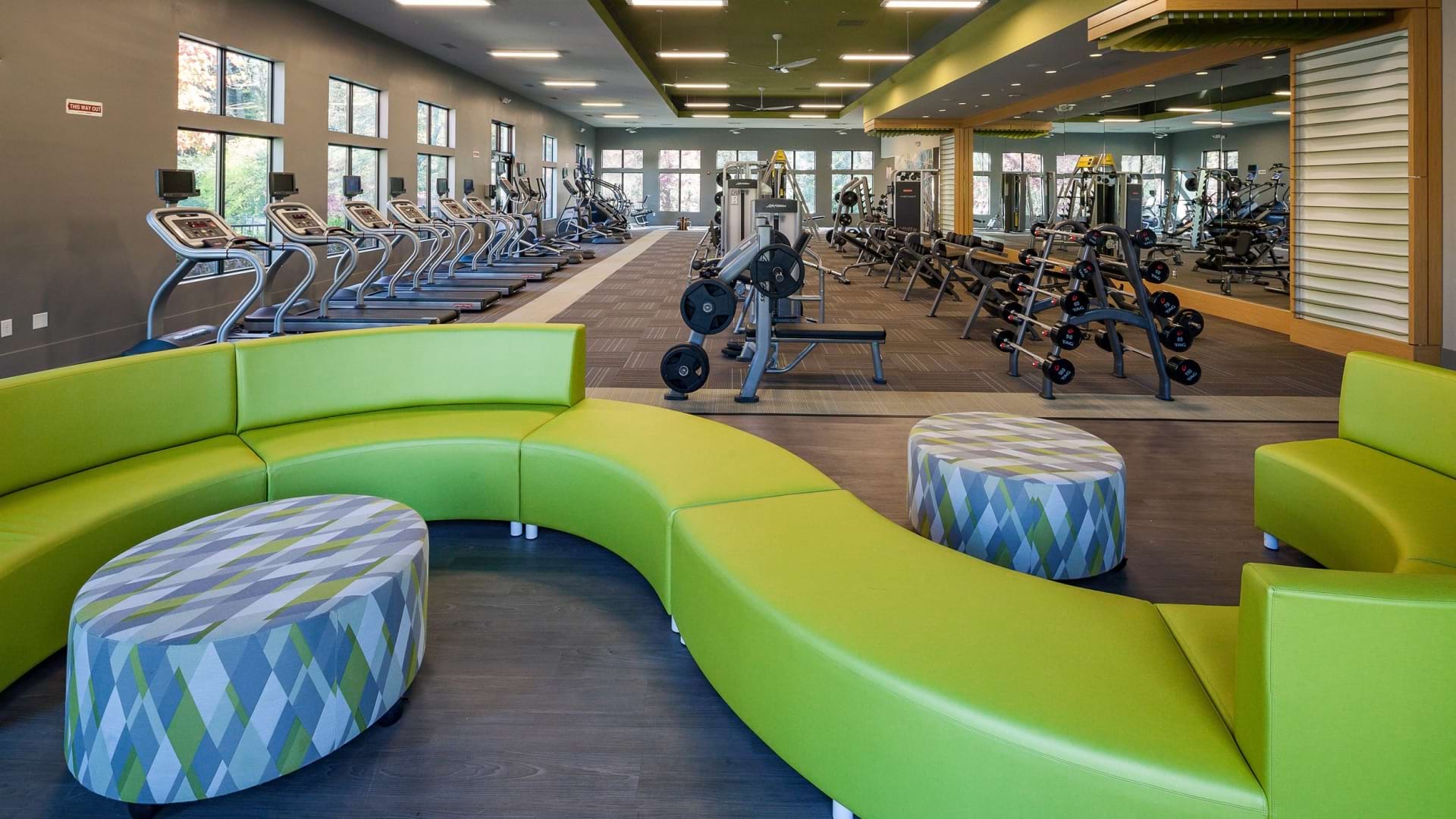Fitness equipment and lounge area at our Lake Village East apartment gym