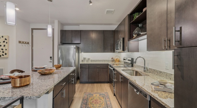 Custom Cabinetry with Under-Cabinet Lighting and Designer Hardware at Our Apartments for Rent in Kissimmee, FL