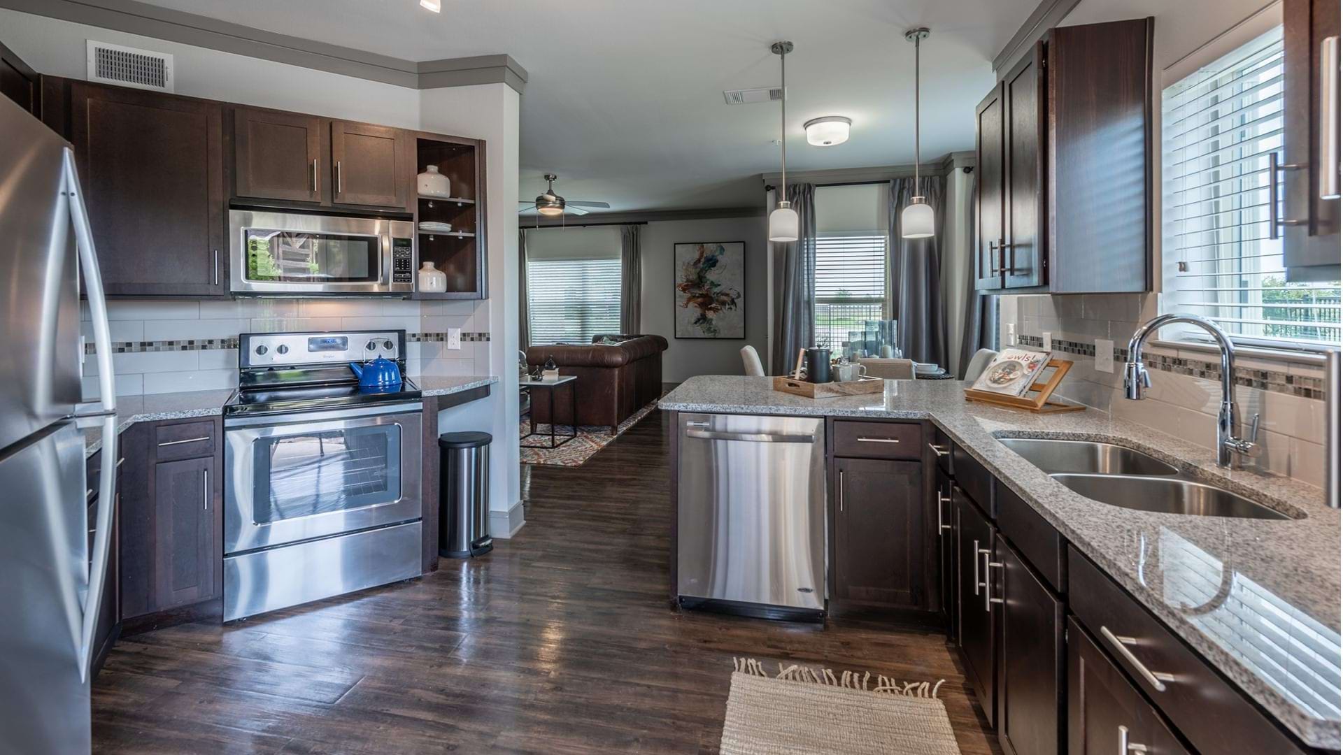 Spacious kitchen with modern lighting at our luxury apartments in Prosper, TX
