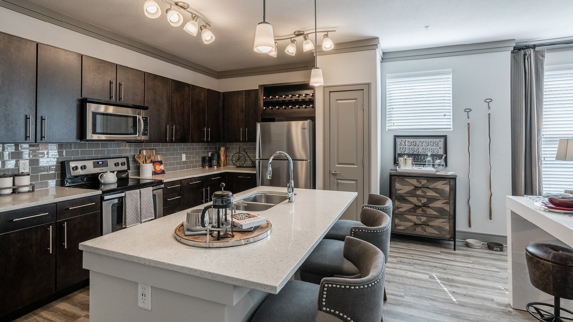 Expansive Kitchen Island with Modern Lighting At Our Broomfield Apartments