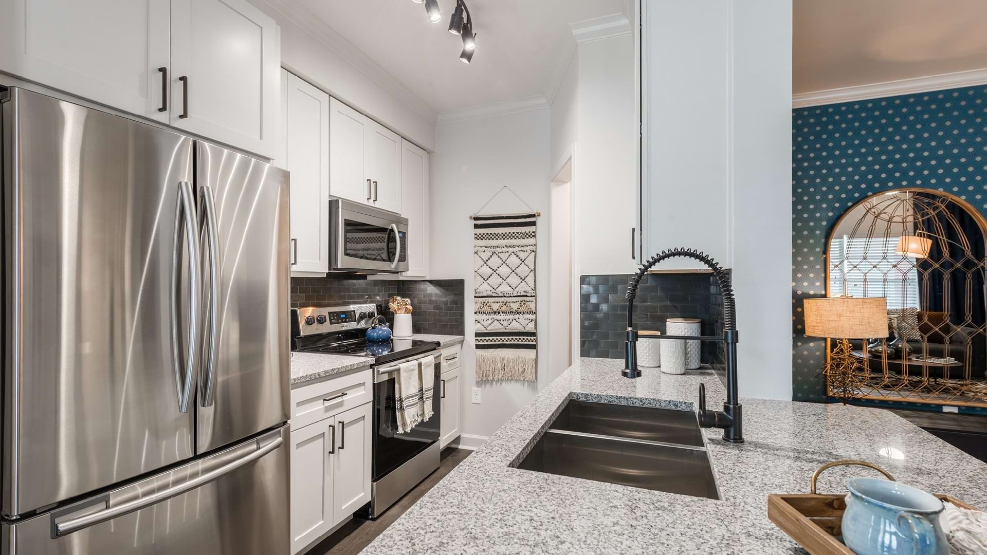 Kitchen with sleek granite countertops and energy-efficient appliances at our modern apartments for rent in Cypress, TX