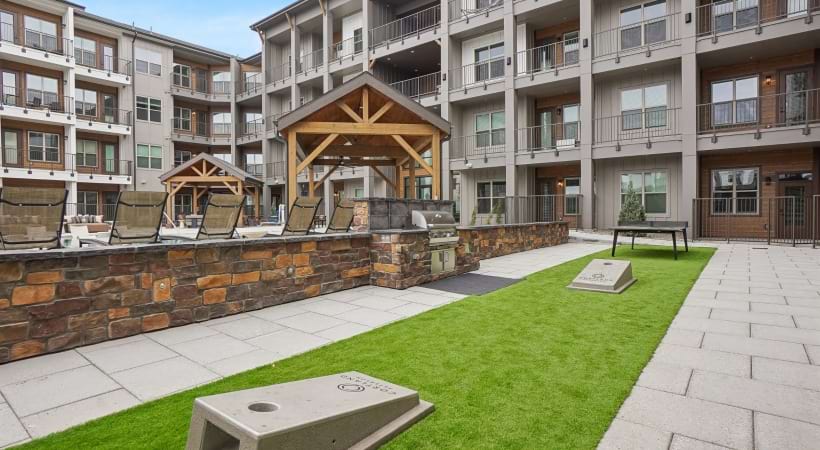 Outdoor Game Space with Cornhole at Our Peterson AFB Apartments