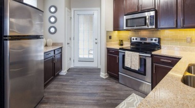 Open-Concept Kitchen with Sleek Granite Countertops and Energy Efficient Appliances at Our University City Apartments