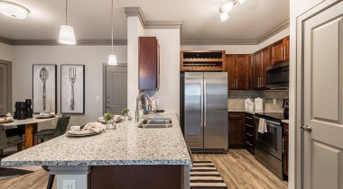Upscale Kitchen with Granite Countertops and Stainless Steel Appliances at Our New Apartments in Morrisville, NC