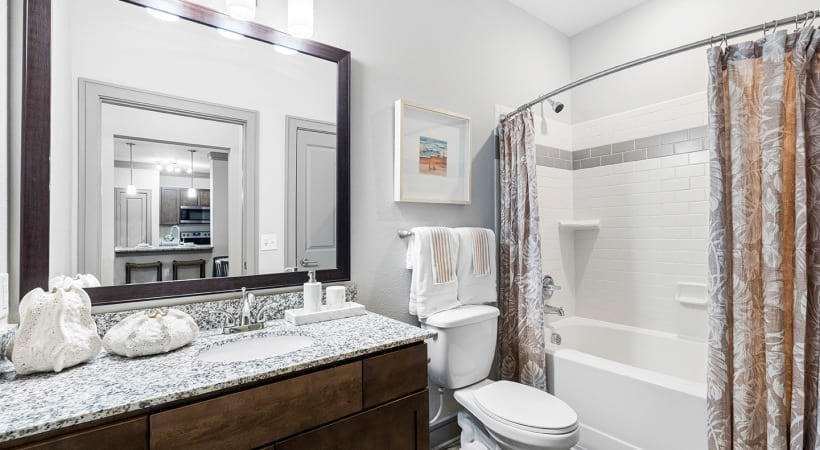 Bathroom with Sleek Granite Countertops at Our Apartments for Rent in Lake Buena Vista, FL