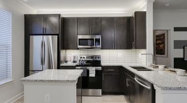 Kitchen area with stainless steel appliances and granite countertops