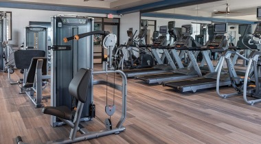 Rows of Exercise Equipment in 24/7 Fitness Center at Our Apartments for Rent in Orlando, FL
