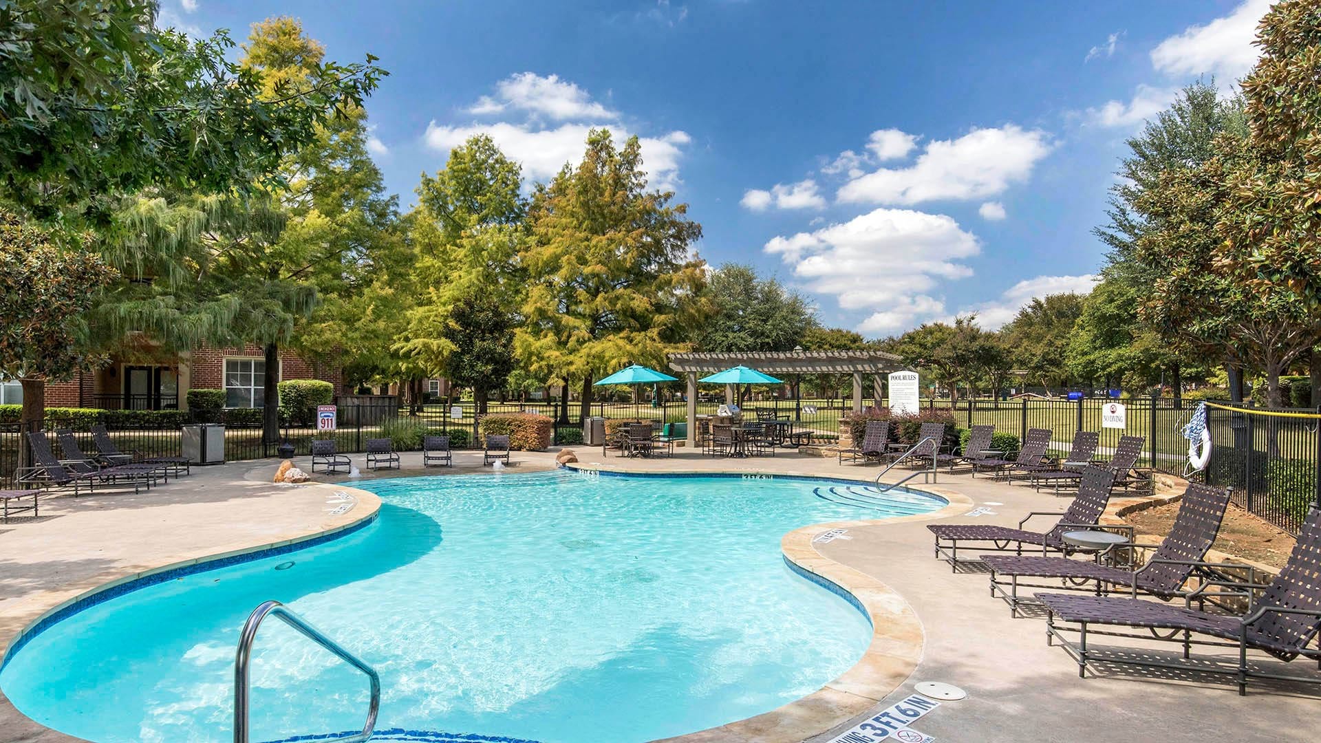 Resort-Style Swimming Pool with Lounge Chairs at Our West Plano Apartments