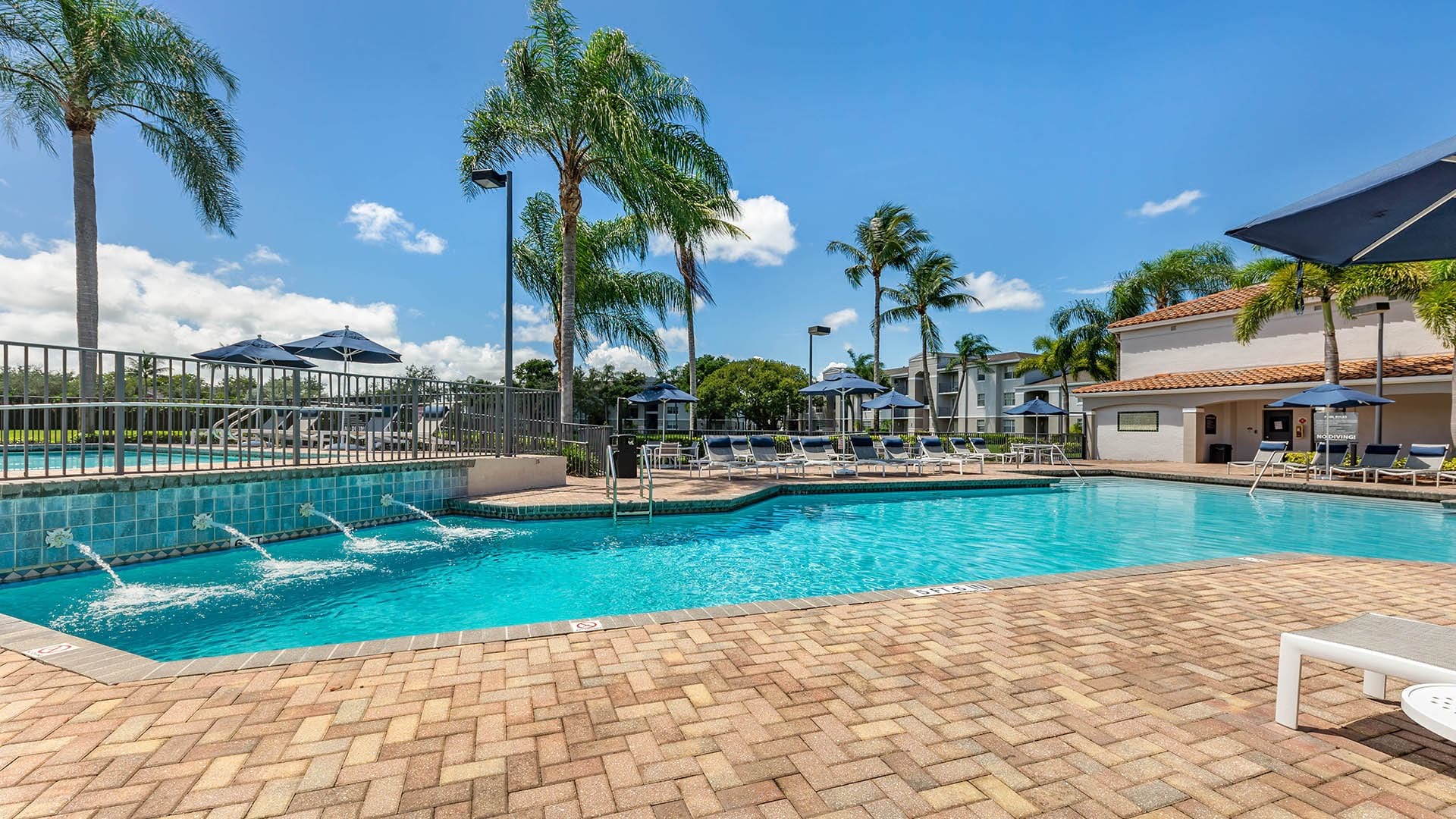 Sparkling Resort-Style Pool with Wading Pool Nearby at Our Pembroke Pines Apartments