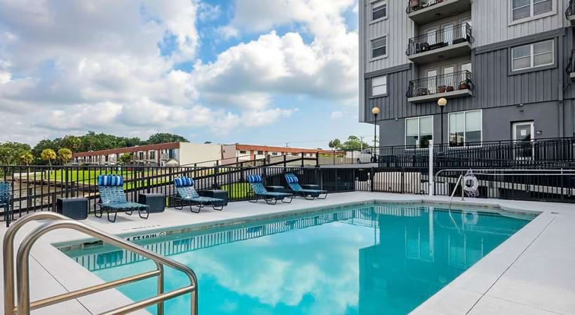 Swimming Pool with Lounge Chairs at Our Apartments Near Ormond Beach, FL