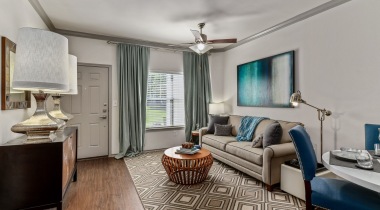 Living room with wood-style flooring at our Colony apartments near Lewisville Lake