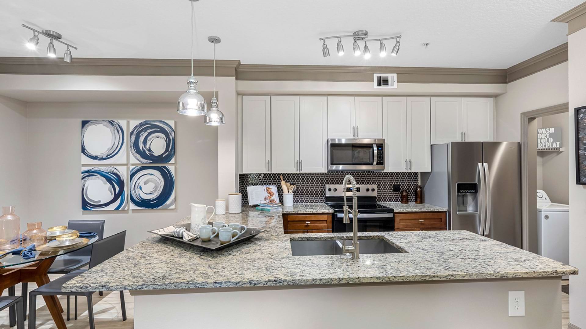 Upscale Kitchen with Stainless Steel Appliances and Granite Countertops at Our Apartments Near Seminole State College