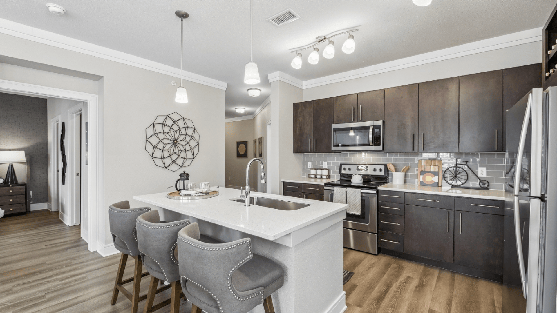 Expansive Kitchen Island with Modern Lighting At Our Broomfield Apartments
