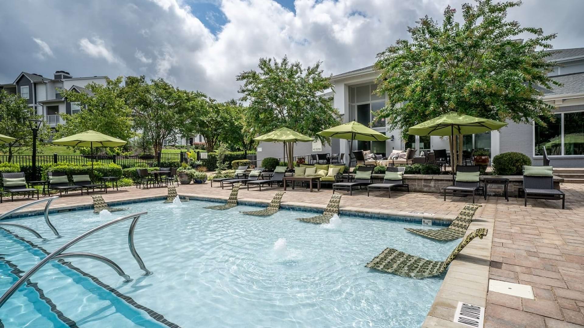 Resort-Style Pool with In-Water Lounge Chairs at Our Southpoint Apartments