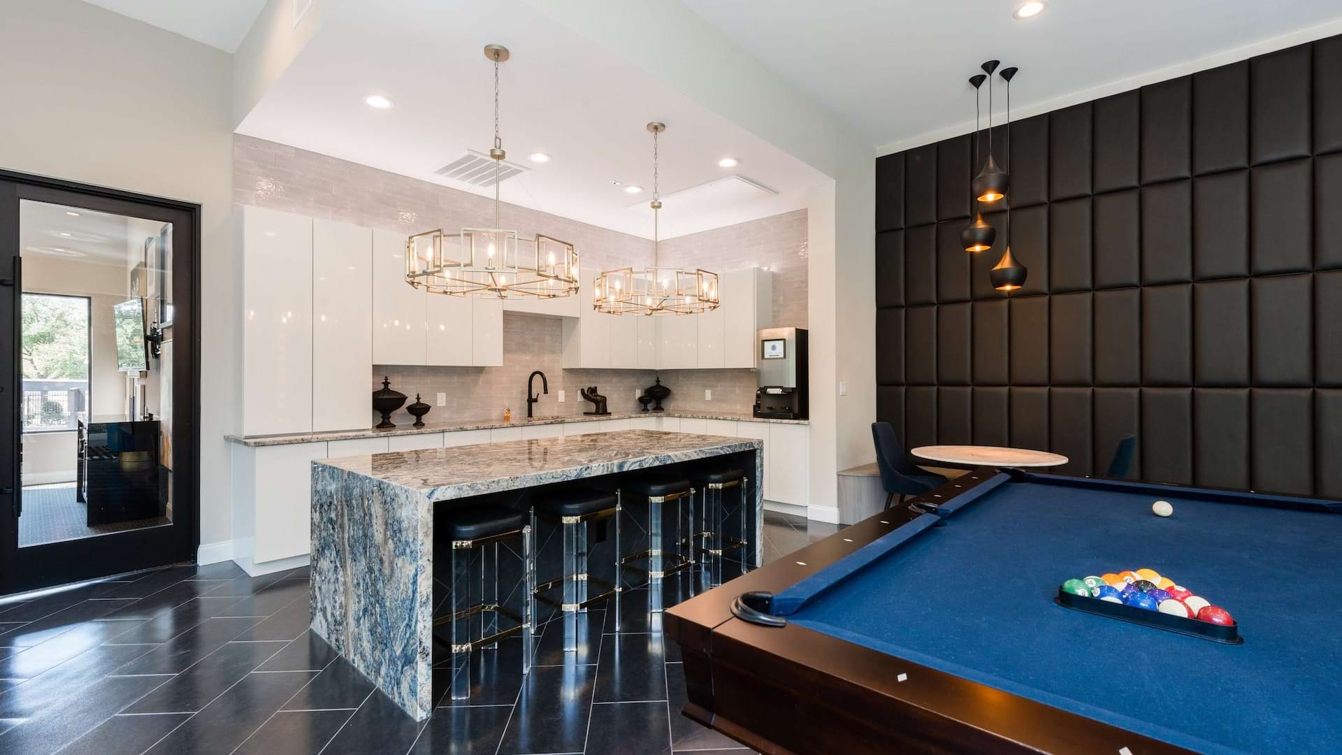 Modern resident clubhouse with a pool table and coffee bar at our upscale Dallas North apartments