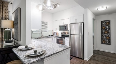Modern apartment kitchen with sleek granite countertops at our Irving apartments for rent 