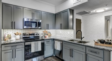 Kitchen with stainless steel appliances at our apartments for rent in Plano, TX