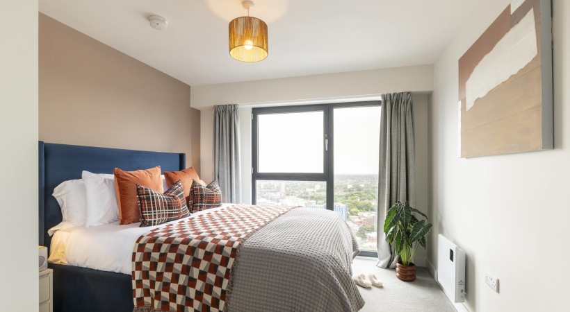 Bedroom with Floor-to-Ceiling Windows at Our Birmingham Apartments 
