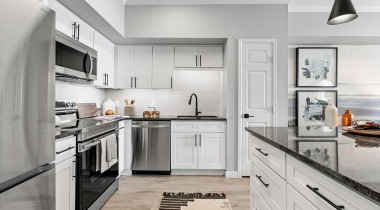 Kitchen with Custom Cabinetry at Our City Park Apartments in Denver