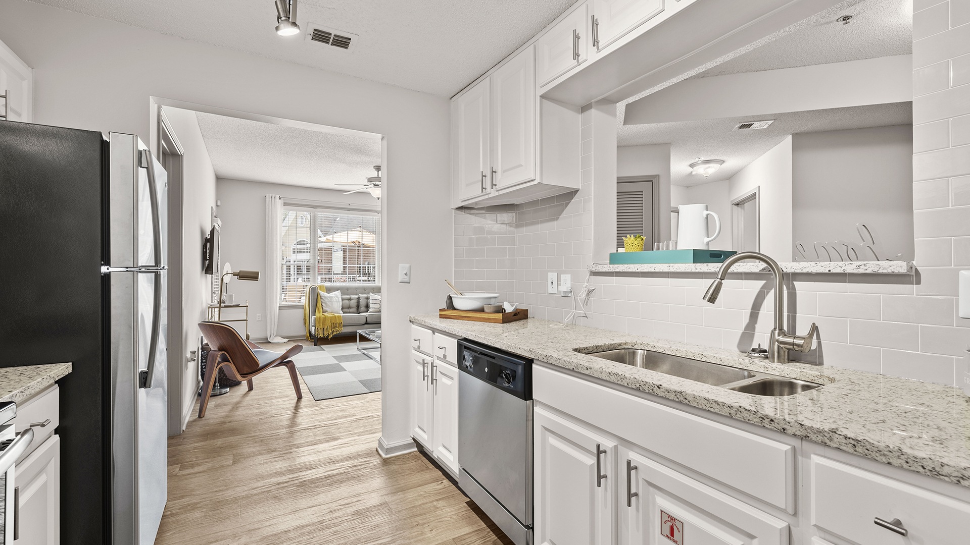 Kitchen with White Shaker Cabinetry and Stainless Steel Appliances at Our Sandy Springs, Atlanta Apartments