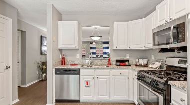Kitchen with Cabinets for Storage and Stainless Steel Appliances at Our Sandy Springs Apartments