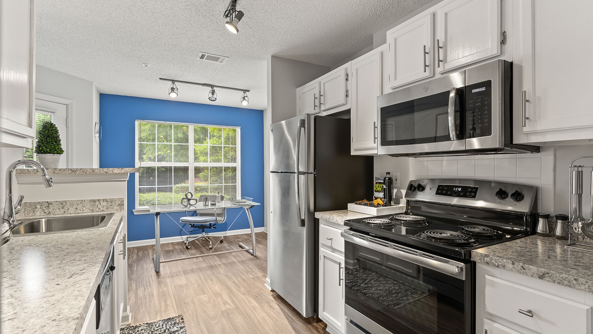 Kitchen with Energy-Efficient, Stainless Steel Appliances and Cabinets for Storage at Our Apartments in Austell