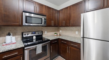Cortland Belgate Apartment Kitchen With Stainless Steel Appliances And Granite Kitchen Island