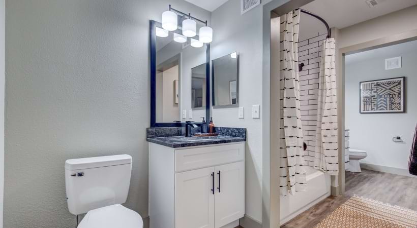Custom Wooden Cabinetry and European-Style Faucet in the Bathroom of Our Thornton Apartments