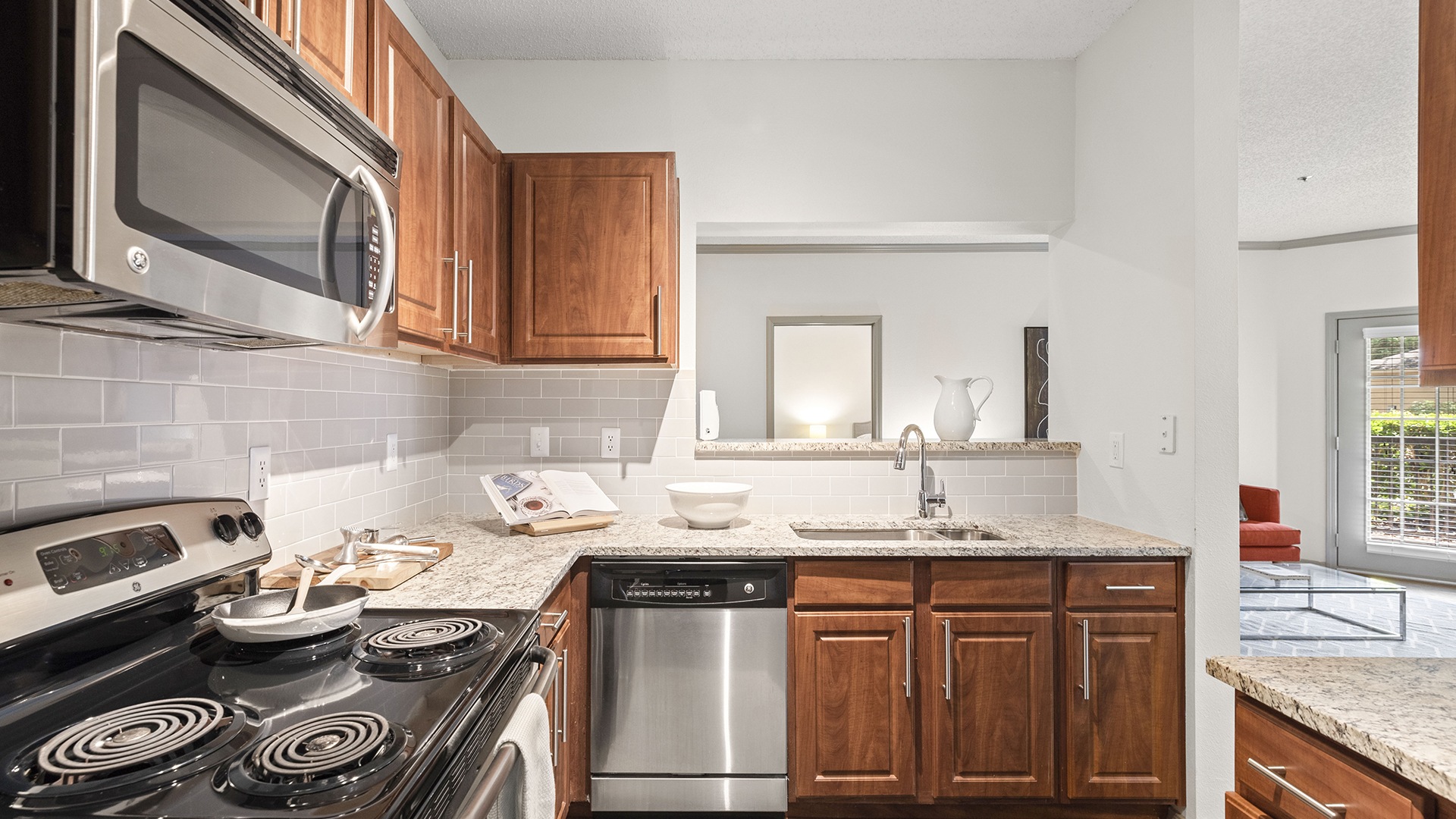 Kitchen with Custom Cabinetry and Stainless Steel Appliances at Our Glenridge Apartments