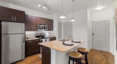 Kitchen island with granite countertops at Cortland Legacy apartments in Frisco, TX