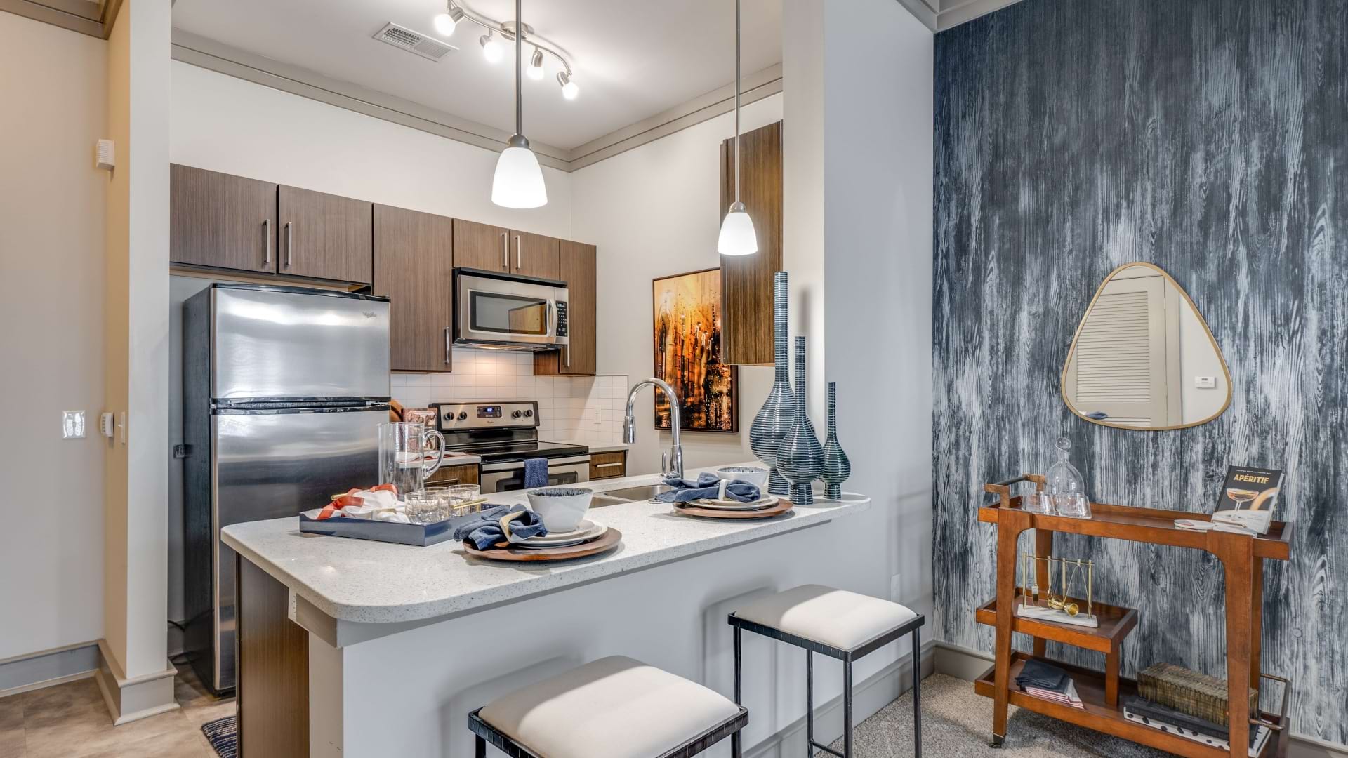 Spacious kitchen and blue accent wall at our modern apartments in Raleigh, NC