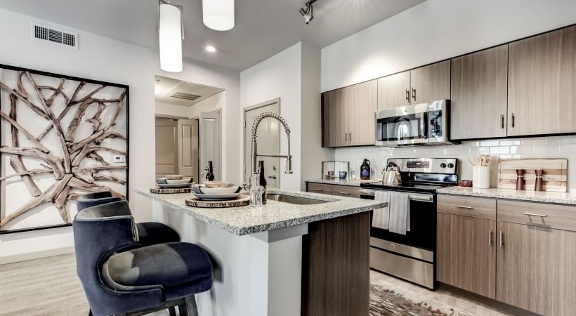 Kitchen Featuring Island with Sink at Our Apartments in Colorado Springs