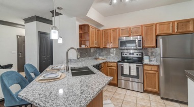 Modern Kitchen With Stainless Steel Appliances And Granite Countertops At Our Upscale South Fort Worth Apartments