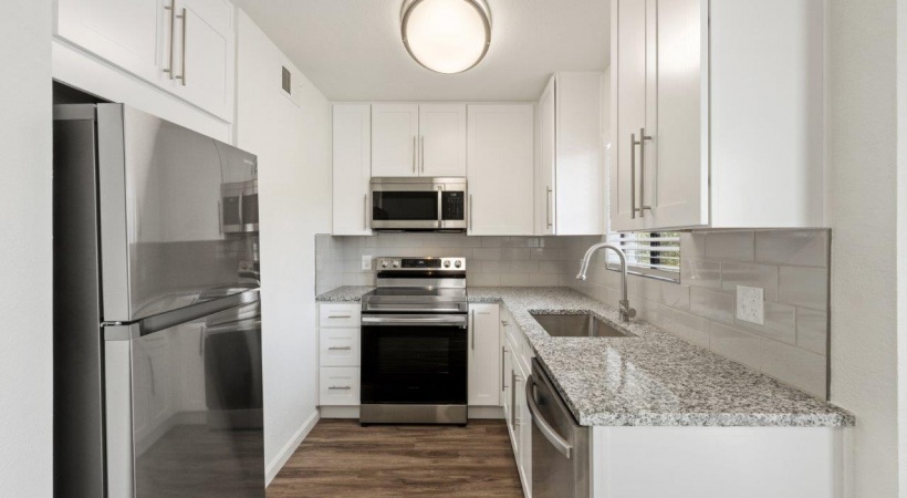 Kitchen with Custom Cabinetry and Under-Cabinet Lighting at Our Tucson Apartments