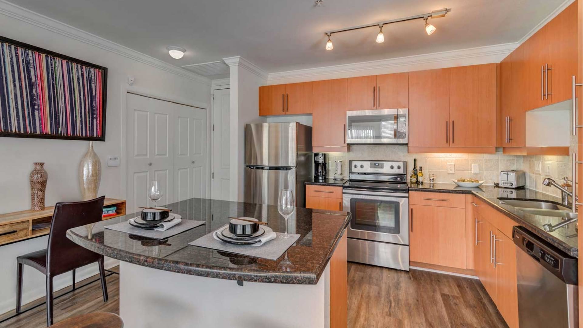 Kitchen with Energy-Efficient, Stainless Steel Appliances and Cabinets for Storage at Our  Uptown Dallas Apartments for Rent