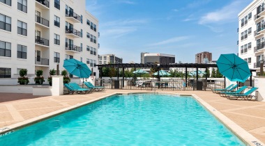 Sparkling Resort-Style Pool with Lounge Chairs at Our West Village Apartments