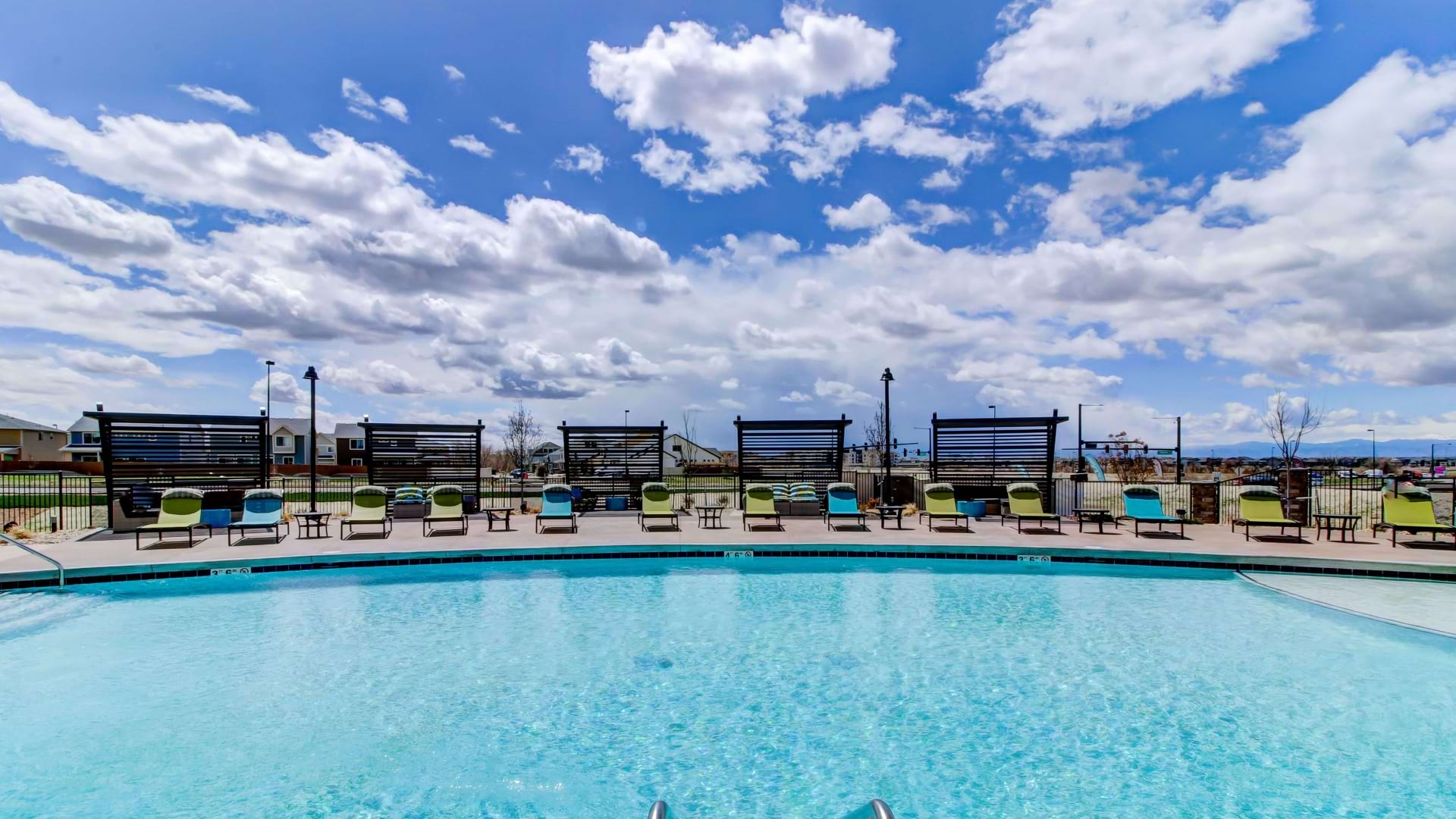 Resort-Style Pool with Lounge Area at Our Green Valley Ranch Apartments with Mountain View