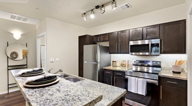 Newly Renovated Kitchen with Granite Countertops and Subway Tile Backsplashes at Our River Road Apartments