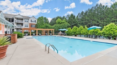 Resort-Style Pool with Outdoor Resident Lounge and Barbecue Grills at Our Apartments on Austell Road in Marietta, GA