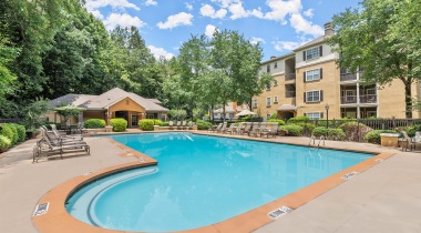 Glenridge Drive Apartments with a Sparkling Swimming Pool Surrounded by Lounge Chairs
