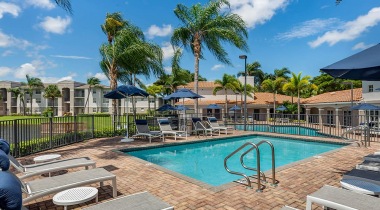 Wading Pool Surrounded by Lounge Chairs at Our Pembroke Apartments
