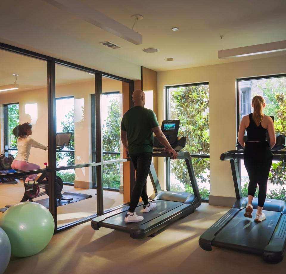Residents Working Out on Treadmills at Our Cortland Apartments for Rent