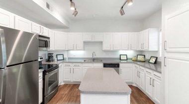 Kitchen with Expansive Island at Our Apartments off Cooper Street in Arlington, TX