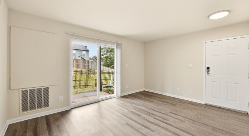 Living Room with Access to a Private Patio at Our Apartments for Rent in Leesburg, VA