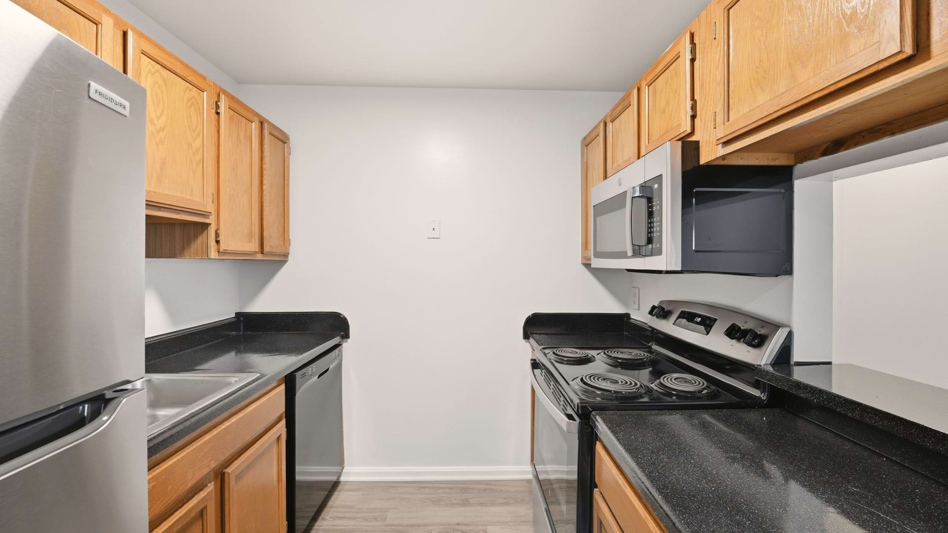 Upscale Kitchen Area with Modern Cabinetry with Designer Hardware at Our Apartments in Loudoun County