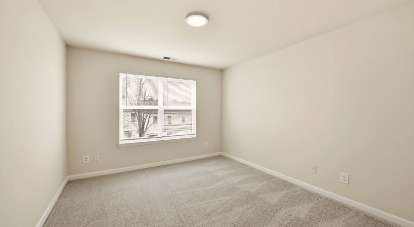 Spacious Bedroom with Large Windows at Our Apartments in Leesburg