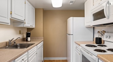Kitchen with Expansive Cabinet Storage at Our Apartments in Rosslyn