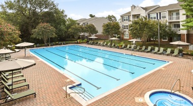Resort-Style Pool and Sun Deck with Lounge Chairs at Our Gainesville, VA Apartments for Rent